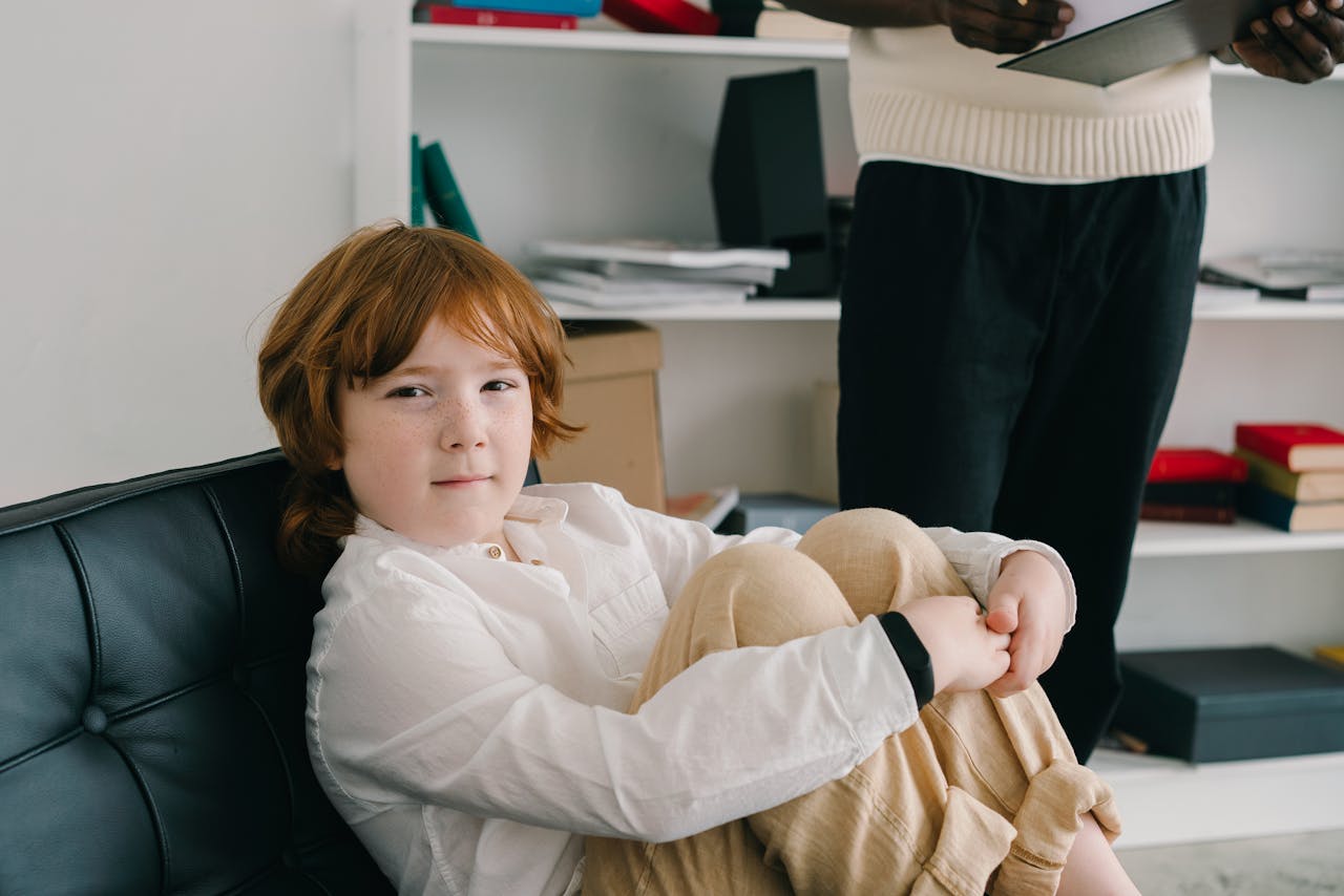 A young boy in a therapy session sitting comfortably indoors, emphasizing child development.