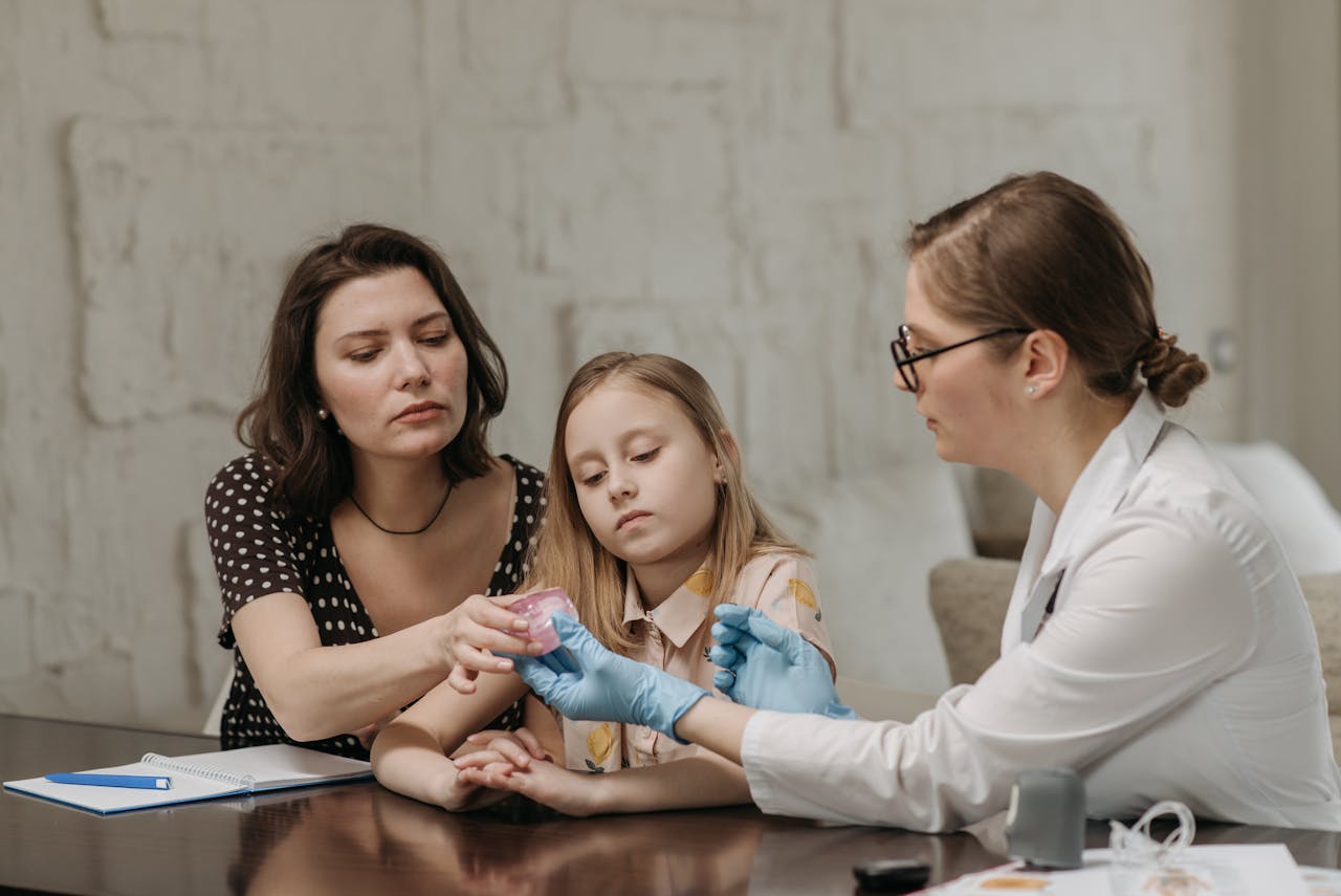 A mother and daughter discuss health options with a female doctor in an office setting.